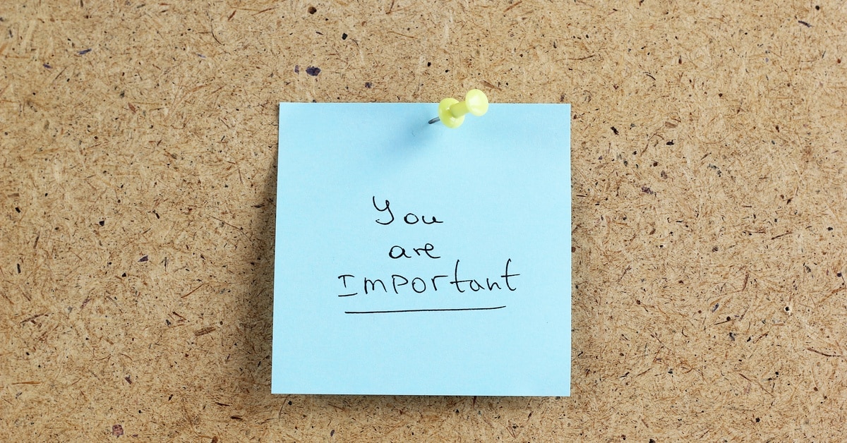 A blue sticky note on a corkboard with a yellow pushpin reading "you are important" with "important" underlined.